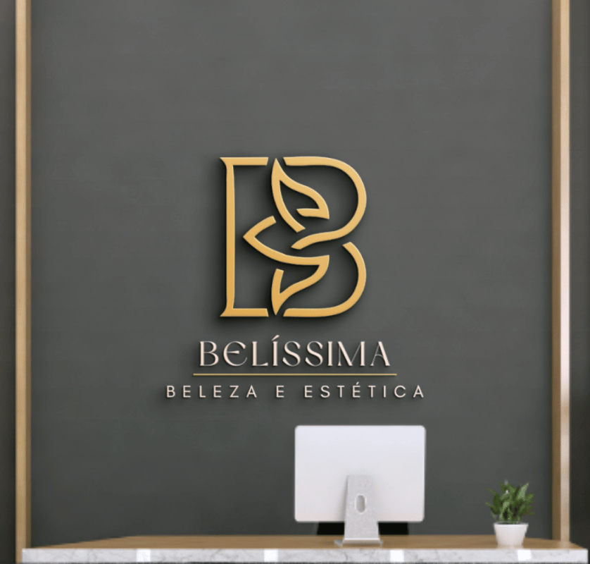 Elegant gold filigree logo 'B' for Belíssima Beleza e Estética, mounted on a grey textured wall in a luxury salon reception mockup by Lorena Palmeira.